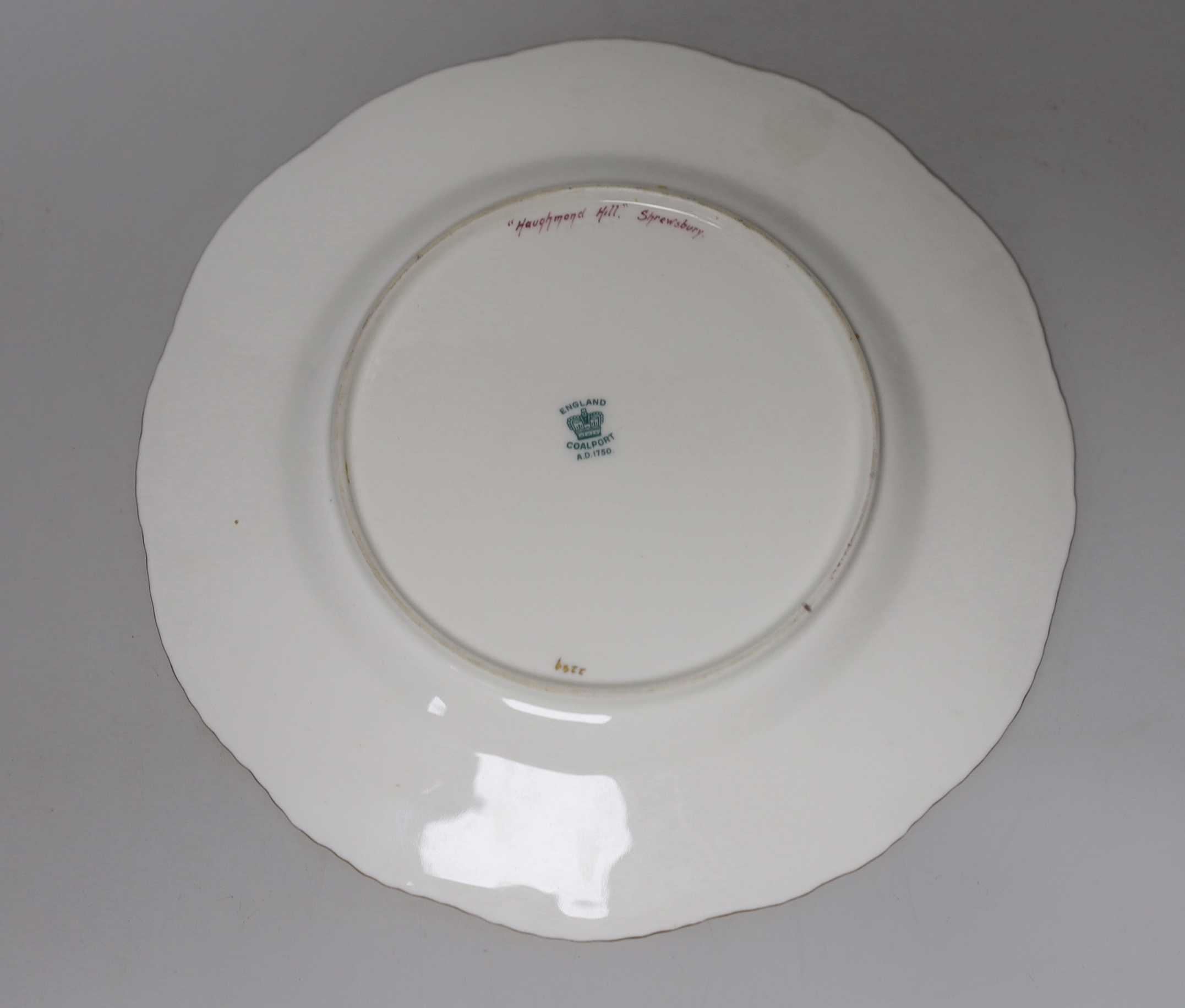A Coalport gadroon-rimmed plate with elaborated blue and gilt border, painted with a central landscape in gilt panel by P. Simpson, signed, the panel titled 'Haughmond Hill, Shrewsbury' verso, Crown, England Coalport mar